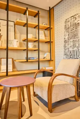 a room with a table and a bench and shelves at Terrasses and Sunset Duplex Luxe 3 Bed in Ghandi in Casablanca