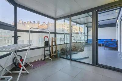 a room with a balcony with a ladder and windows at Terrasses and Sunset Duplex Luxe 3 Bed in Ghandi in Casablanca