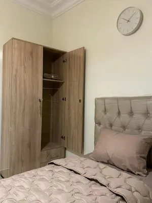 a bedroom with a bed and a clock on the wall at 3-Bedroom Apartment - Rabat - 2Baths & 2Balconies in Rabat