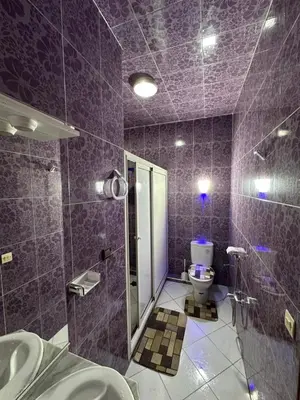 a purple bathroom with a toilet and a sink at 3-Bedroom Apartment - Rabat - 2Baths & 2Balconies in Rabat