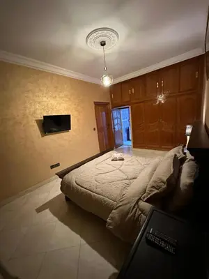 a bedroom with a large bed and a television at 3-Bedroom Apartment - Rabat - 2Baths & 2Balconies in Rabat