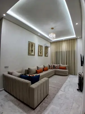 a large living room with couches and a couch at Studio Cosy avec Piscine & proche de la plage in Aïn Harrouda