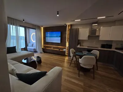 a living room with a couch and a table at Luxury 1 bedroom at La marina in Casablanca