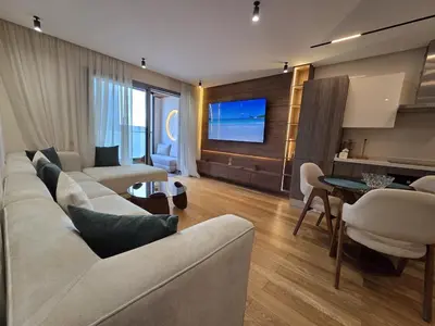 a living room with a couch and a table at Luxury 1 bedroom at La marina in Casablanca