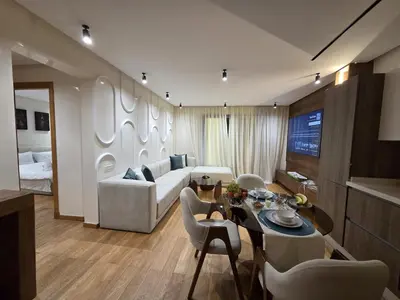 a living room with a couch and a table and chairs at Luxury 1 bedroom at La marina in Casablanca