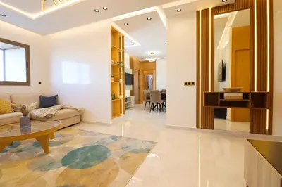 a living room with a couch and a table at Le Nour- 2 modern bedrooms Luxury and Comfort in Bouznika