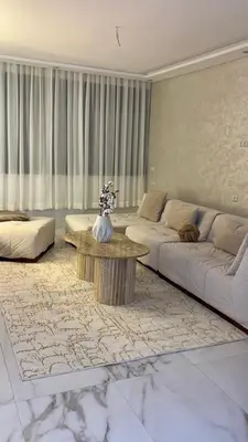 a living room with two couches and a coffee table at Appartement neuf vue mer sur la corniche in Rabat