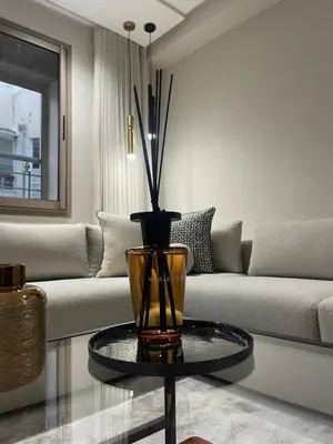 a living room with a couch and a vase on a table at Studio a 2 pas des TWINS CENTER boulevard Massira Khadra in Casablanca