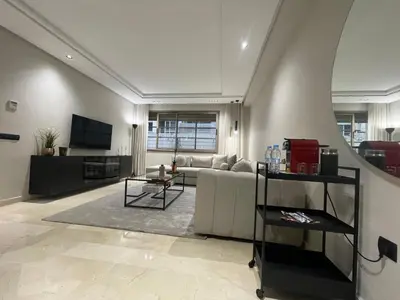 a living room with a couch and a tv at Studio a 2 pas des TWINS CENTER boulevard Massira Khadra in Casablanca