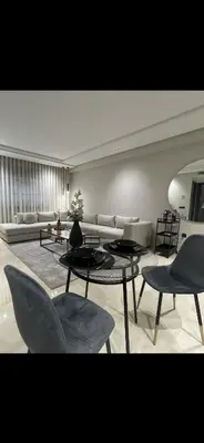 a living room with a couch and tables and chairs at Studio a 2 pas des TWINS CENTER boulevard Massira Khadra in Casablanca