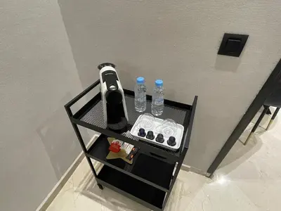 a table with two bottles of water and a remote control at Studio Chic proche Twins Center in Casablanca