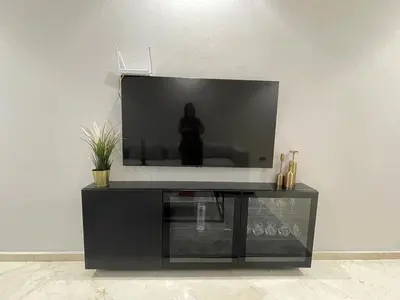 a black entertainment center with a flat screen tv at Studio Chic proche Twins Center in Casablanca