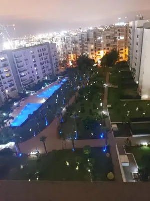 a view of a park in a city at night at Prestigia Luxurious 3BR 5 min walk from stadium in Rabat