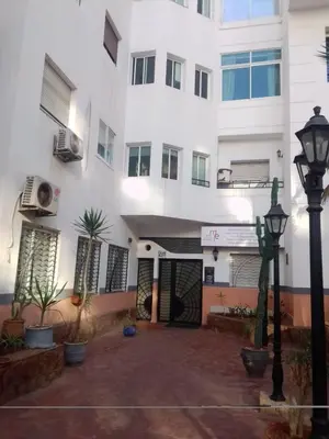 a building with a street light in front of it at Appartement dans le centre de la plage de av Tantan in Casablanca