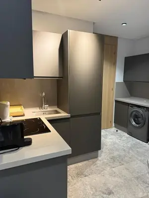 a kitchen with a refrigerator and a sink and a stove at 2 bedrooms in the heart of Casablanca in Casablanca