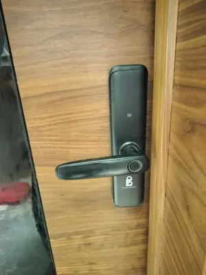 a black door latch on a wooden door with a cell phone at Luxury Stay in Casablanca in Maarif