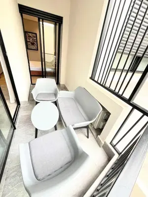 a room with a couch and a table and a window at Appartement CFC in Casablanca