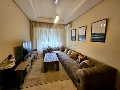 a living room with a couch and a television at A Comfortable Escape In Morocco in Casablanca