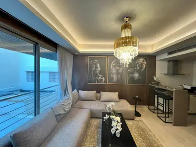 a living room with a couch and a chandelier at residence socrate in Casablanca