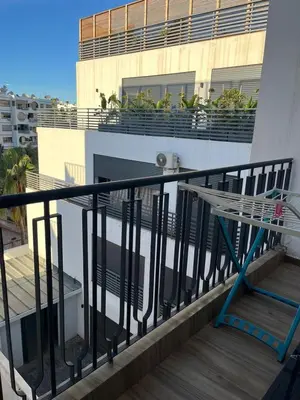 a balcony with a railing and a building at Studio Les princesses in Maarif