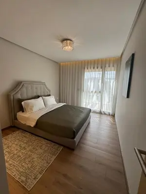 a bedroom with a bed and a large window at Rabat Atlantic Océan in Rabat