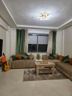 a living room with a couch and a table at appartement luxe dt5 in Mohammedia