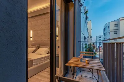 a small balcony with a bed and a table at Luxury Studio Apartment - Maarif Near CFC & Downtown in Casablanca