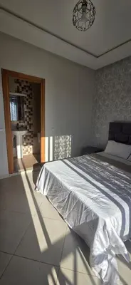 a bedroom with a large bed in a room at luxury apartment DT2 in Mohammedia