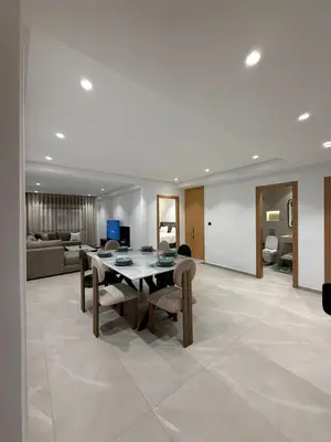 a living room with a table and chairs and a couch at Apartment in Rabat Ocean Absolute Refinement in Rabat