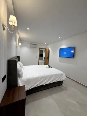 a bedroom with a bed and a tv on the wall at Apartment in Rabat Ocean Absolute Refinement in Rabat