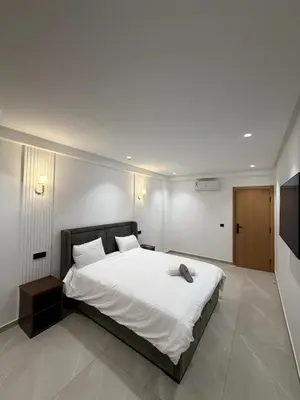 a bedroom with a large white bed and a television at Apartment in Rabat Ocean Absolute Refinement in Rabat