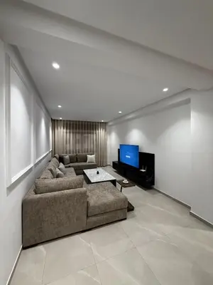a living room with a couch and a flat screen tv at Apartment in Rabat Ocean Absolute Refinement in Rabat