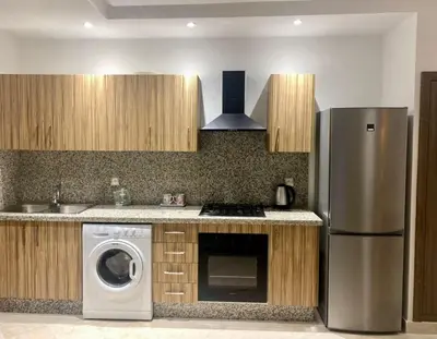 a kitchen with a refrigerator and a washing machine at Cozy studio with terrace - Mohammedia Center in Mohammedia