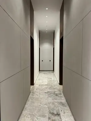 a hallway with white walls and a tile floor at A Suites in Casablanca