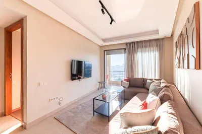 a living room with a couch and a tv at Urban Escape Designer Apartment with Balcony in Casablanca