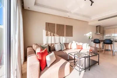 a living room with a couch and a table at Urban Escape Designer Apartment with Balcony in Casablanca