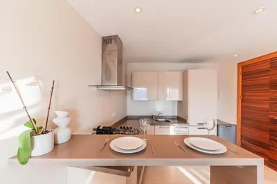 a kitchen with a table with two plates on it at Urban Escape Designer Apartment with Balcony in Casablanca