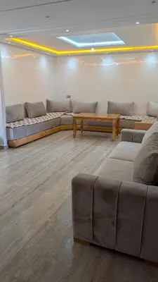 a living room with couches and a table and a couch at appartement en bord de mer Rabat in Rabat