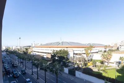 a city street with a building and a road with cars at Modern Studio in Maarif 16 with Free Private Parking in Casablanca