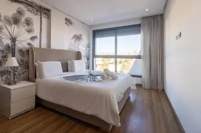 a bedroom with a bed and a large window at Modern Studio in Maarif 16 with Free Private Parking in Casablanca