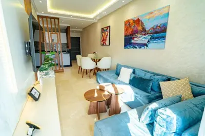 a living room with a blue couch and a table at Studio in Casablanca