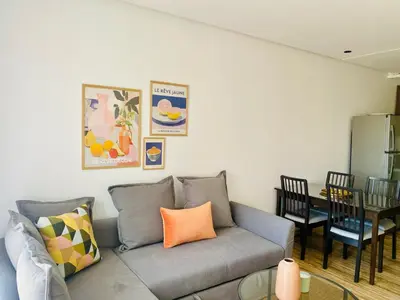 a living room with a gray couch and a table at Welcome Stay Centre Casa Gares &Tram in Casablanca