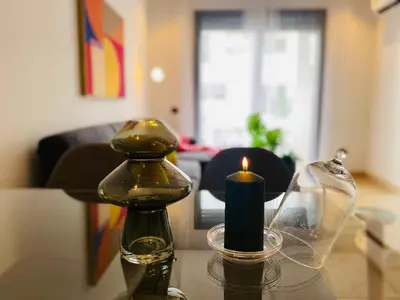 a candle and a bottle on a table at Welcome Stay Centre Casa Gares &Tram in Casablanca