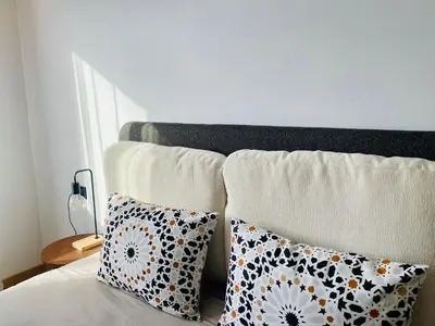 a bed with two pillows on top of it at Welcome Stay Centre Casa Gares &Tram in Casablanca