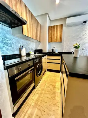 a kitchen with a stove and a dishwasher at Charming Studio in Zenata Eco-city, Pool and Sea View in Aïn Harrouda