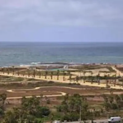 a view of a beach with the ocean in the background at Charming Studio in Zenata Eco-city, Pool and Sea View in Aïn Harrouda