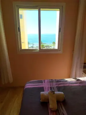 a bedroom with a bed with a large window at Elegant apartment with sea view in Rabat