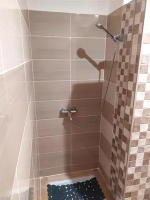 a shower with a shower head in a bathroom at Elegant apartment with sea view in Rabat