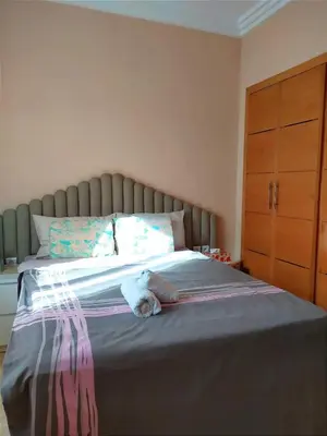 a stuffed animal is laying on a bed at Elegant apartment with sea view in Rabat