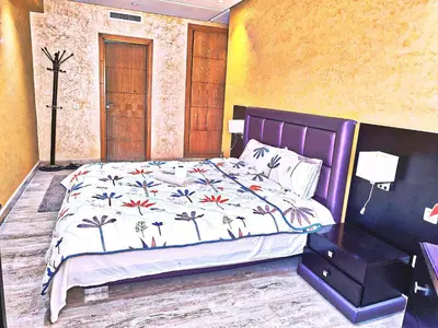 a bedroom with a bed and a nightstand next to it at Bonheur Au bord de la mère in Casablanca
